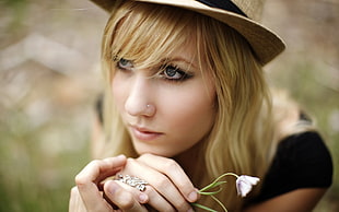 portrait photo of woman wearing gray hat with blonde hair